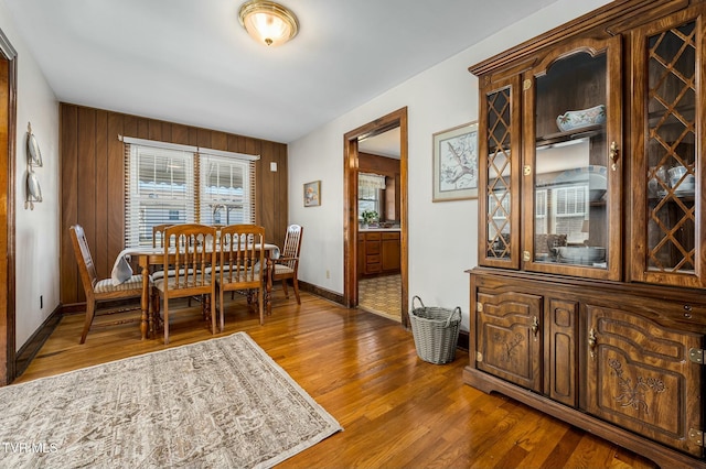 dining area featuring baseboards and wood finished floors