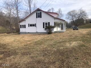 view of property exterior with crawl space and a yard