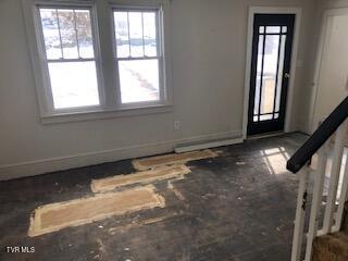 spare room featuring baseboards and plenty of natural light