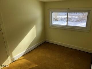 empty room featuring baseboards