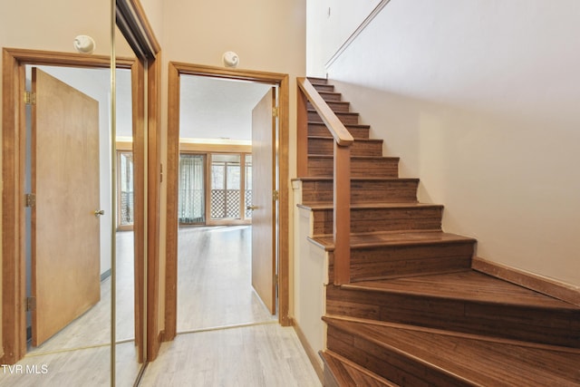 stairway with wood finished floors