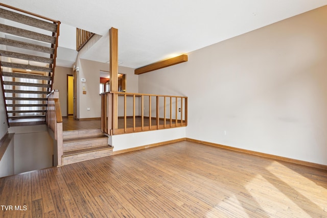 staircase with hardwood / wood-style flooring and baseboards