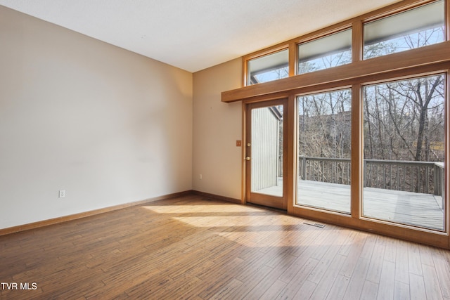 entryway featuring visible vents, light wood-style flooring, and baseboards