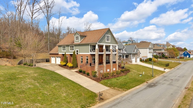 view of front of home featuring a front yard, an attached garage, a residential view, concrete driveway, and brick siding