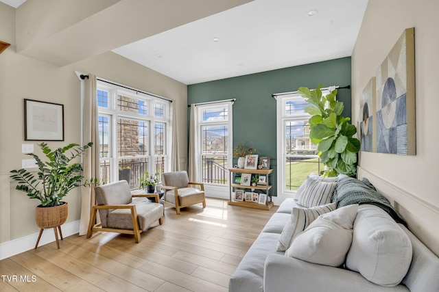 living room featuring recessed lighting, light wood-style flooring, and baseboards