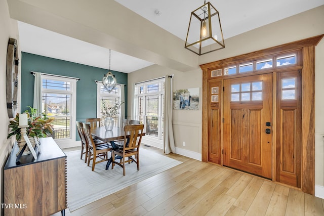 interior space featuring a notable chandelier, visible vents, and light wood finished floors