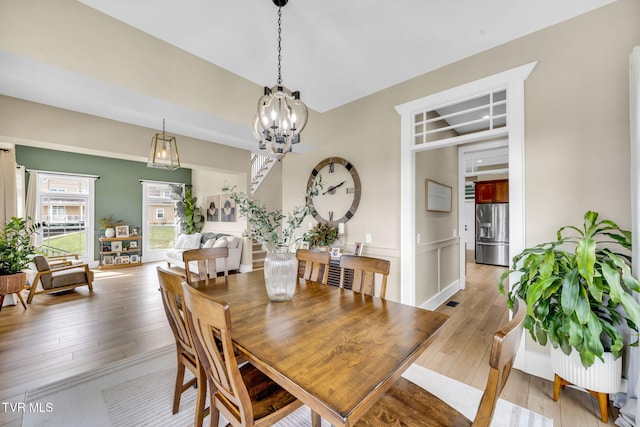 dining room with an inviting chandelier and light wood-type flooring