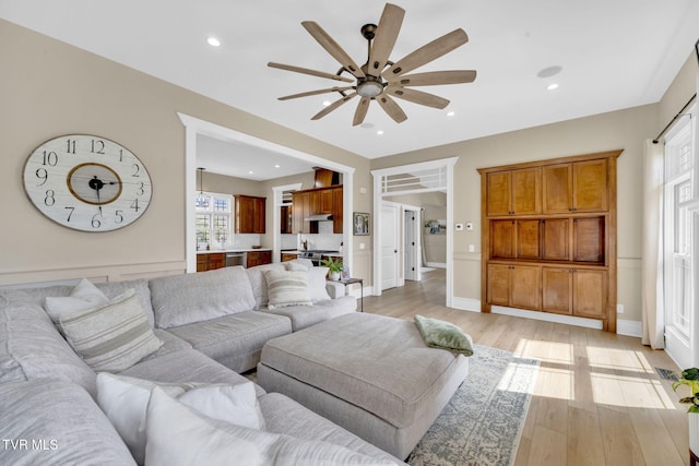 living room with recessed lighting, light wood-style floors, and a ceiling fan