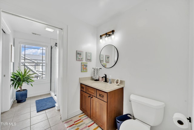 bathroom featuring an enclosed shower, toilet, tile patterned flooring, baseboards, and vanity