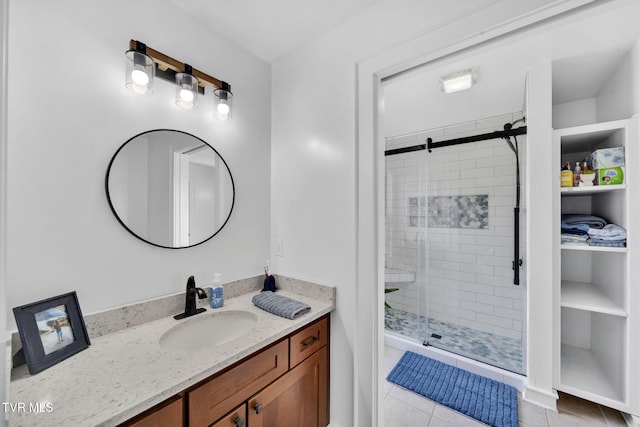 bathroom with vanity, a shower stall, and tile patterned floors