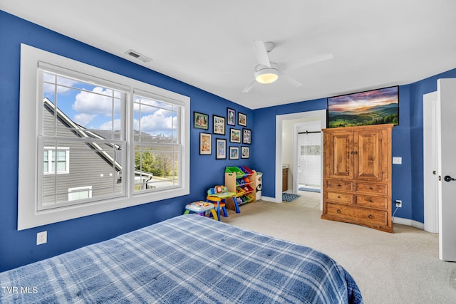 bedroom with baseboards, visible vents, carpet floors, ensuite bath, and ceiling fan