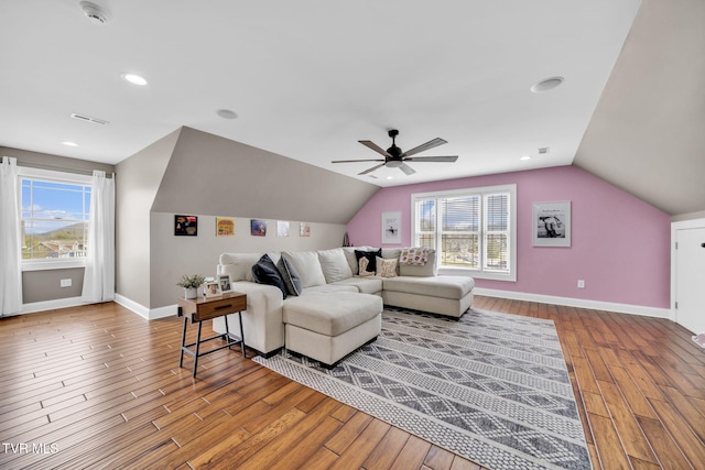 living room featuring ceiling fan, baseboards, plenty of natural light, and wood finished floors