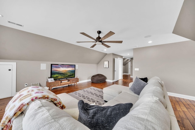 living area featuring baseboards, lofted ceiling, a ceiling fan, and wood finished floors