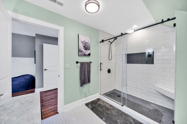 bathroom with visible vents, a shower stall, and baseboards