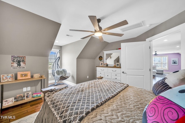 bedroom featuring visible vents, multiple windows, and vaulted ceiling