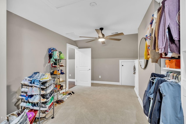 interior space with ceiling fan, baseboards, and vaulted ceiling