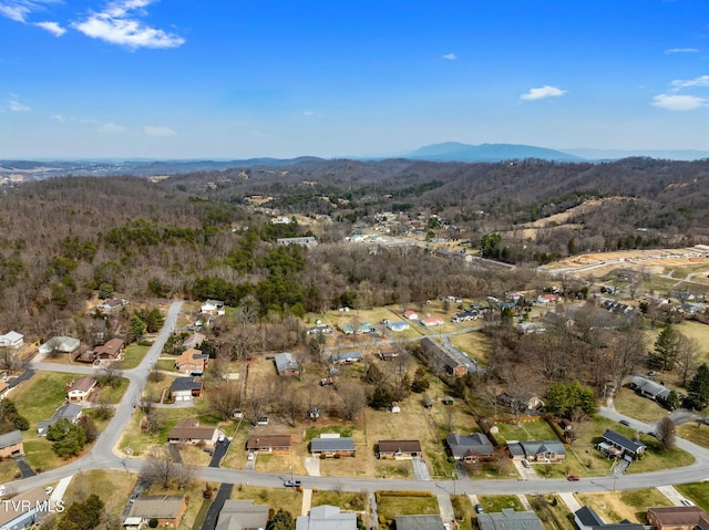 aerial view featuring a forest view and a mountain view