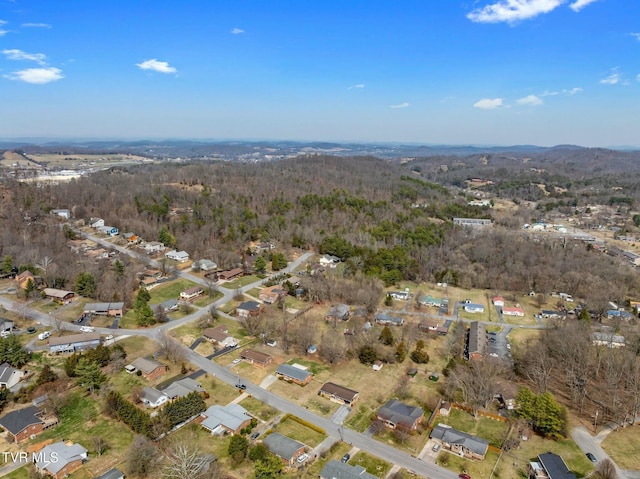 birds eye view of property featuring a view of trees