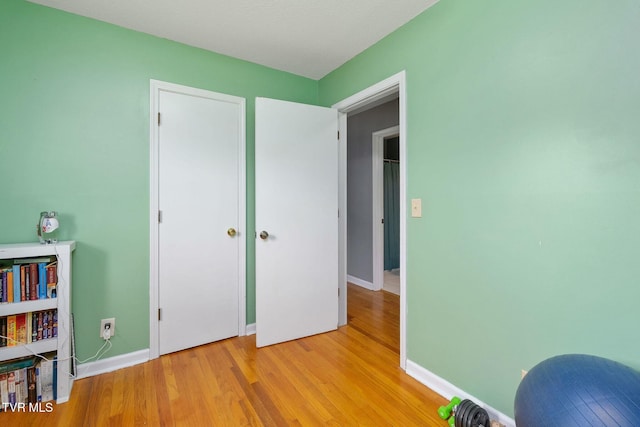 unfurnished room with baseboards and light wood finished floors