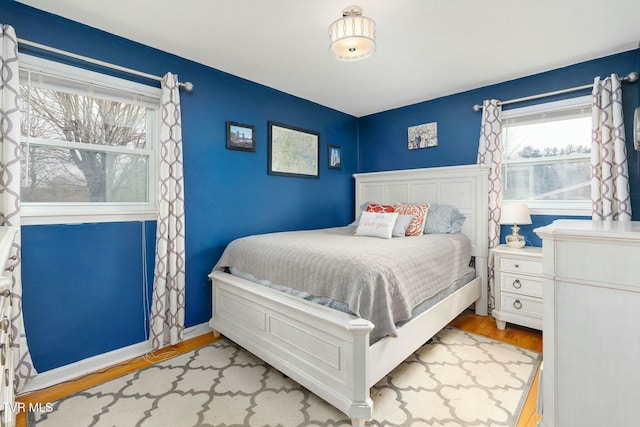 bedroom featuring baseboards and wood finished floors