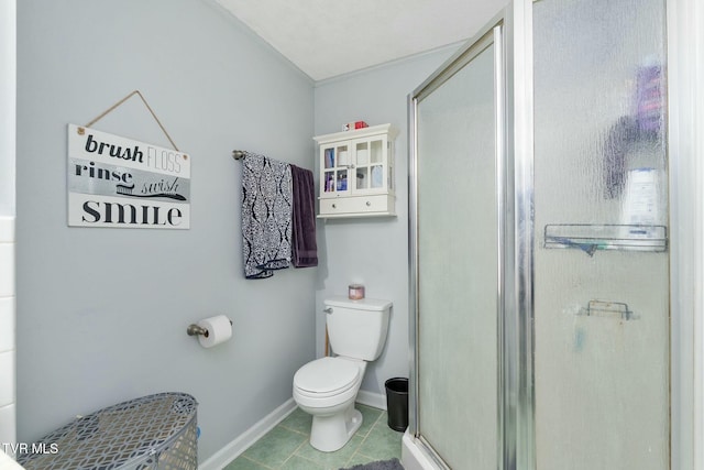 full bathroom with tile patterned flooring, a stall shower, toilet, and baseboards