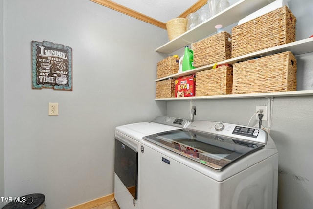 clothes washing area featuring laundry area and washer and clothes dryer