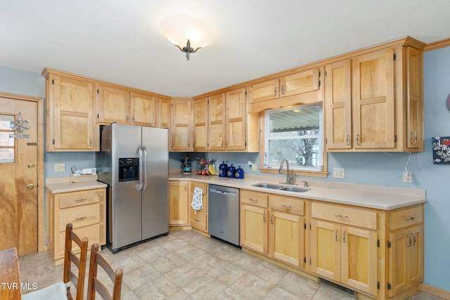 kitchen with visible vents, light brown cabinetry, a sink, light countertops, and appliances with stainless steel finishes