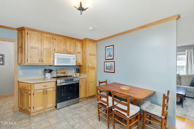 kitchen featuring white microwave, crown molding, baseboards, stainless steel electric stove, and light countertops