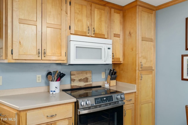 kitchen featuring white microwave, electric range, light brown cabinets, and light countertops