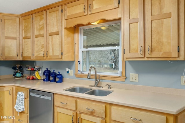 kitchen with light brown cabinetry, dishwasher, light countertops, and a sink