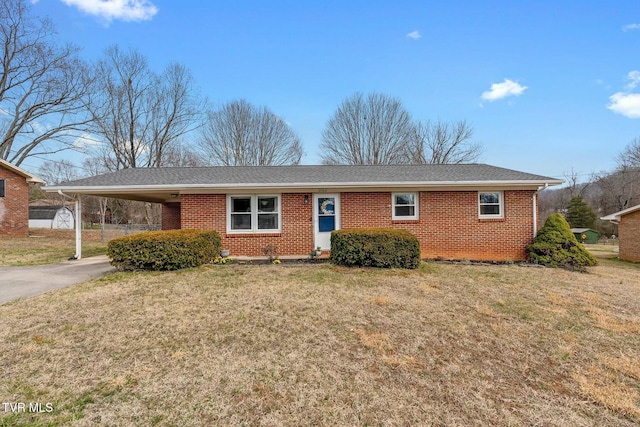 single story home with a front lawn, driveway, an attached carport, roof with shingles, and brick siding