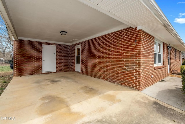 view of patio with a carport and fence