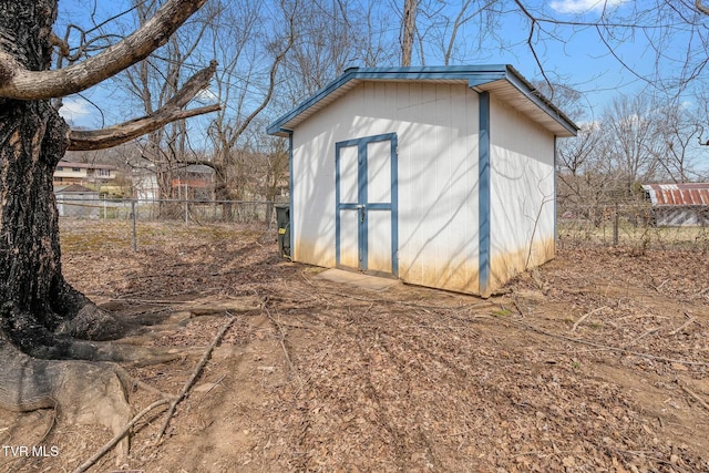 view of shed featuring fence