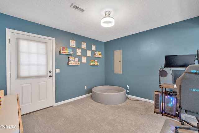 carpeted office featuring electric panel, visible vents, baseboards, and a textured ceiling