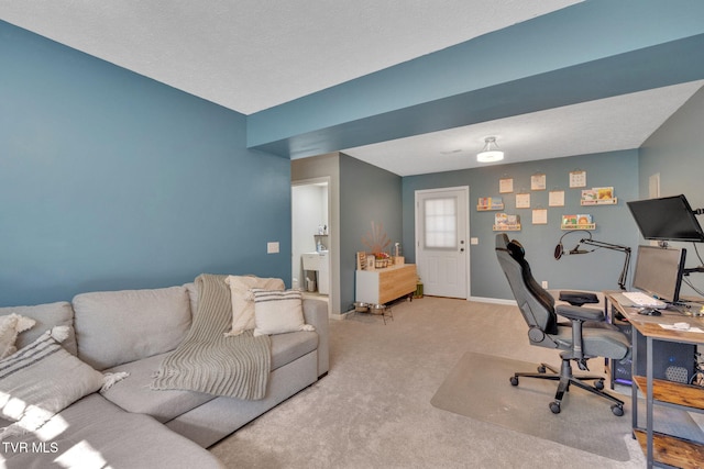 carpeted home office featuring baseboards