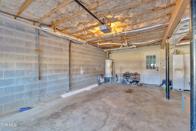 garage with concrete block wall, white refrigerator with ice dispenser, a garage door opener, and water heater