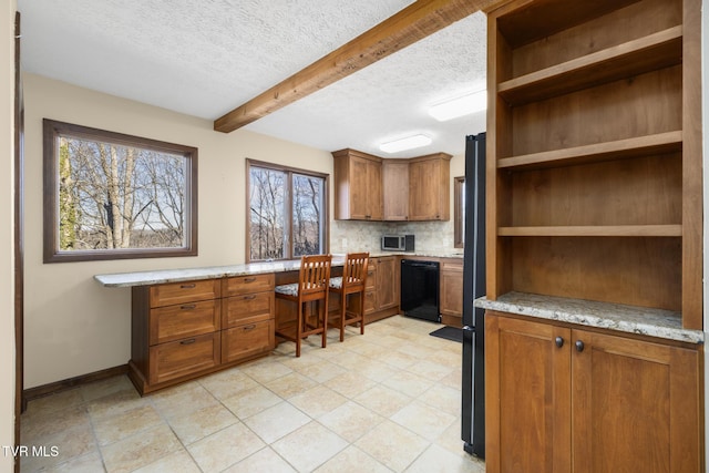 kitchen with open shelves, tasteful backsplash, brown cabinetry, dishwasher, and built in study area