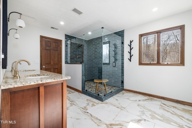 bathroom featuring visible vents, marble finish floor, a shower stall, and baseboards