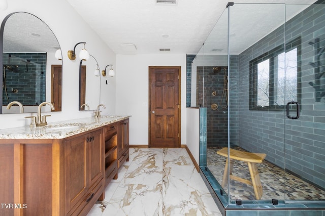 full bath featuring a sink, visible vents, baseboards, and marble finish floor