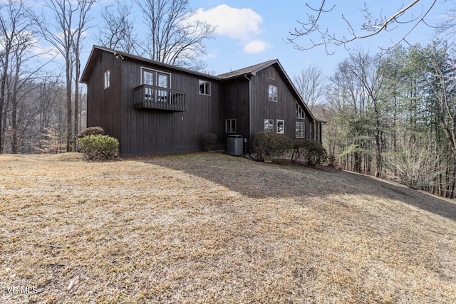 view of front of property featuring central AC unit and a balcony