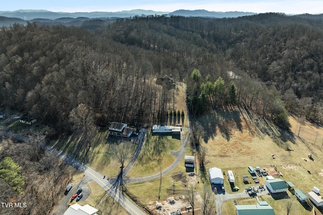 drone / aerial view with a mountain view and a forest view