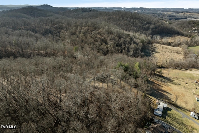 aerial view featuring a mountain view and a wooded view