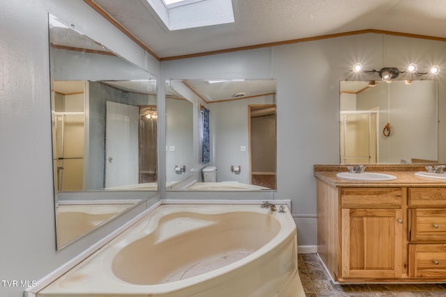 full bathroom with a bath, vaulted ceiling with skylight, double vanity, and a sink