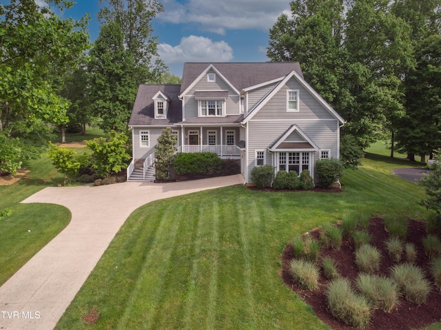 view of front of property featuring a porch, driveway, and a front yard