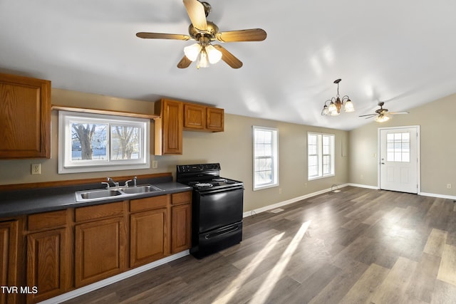 kitchen featuring a sink, dark wood-type flooring, black electric range, dark countertops, and brown cabinets