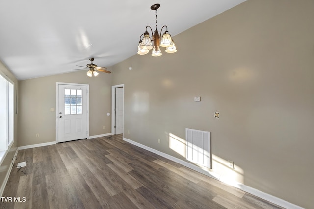 interior space featuring visible vents, ceiling fan with notable chandelier, wood finished floors, baseboards, and vaulted ceiling