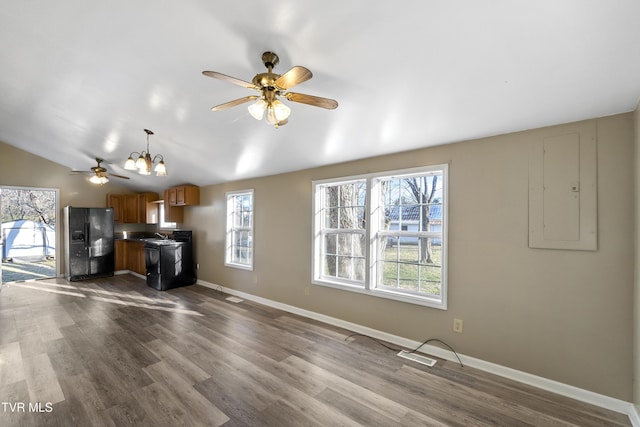 unfurnished living room featuring dark wood-style floors, baseboards, electric panel, ceiling fan, and vaulted ceiling