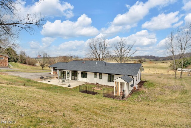2256 Boones Creek Rd, Johnson City, TN 37615 - back of property with fence, roof with shingles, stucco siding, a yard, and a patio