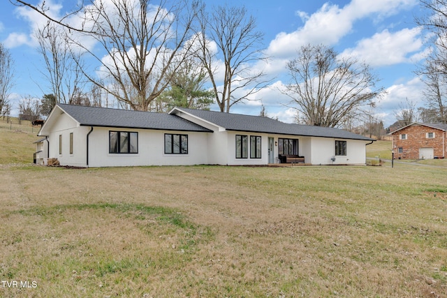 ranch-style house featuring stucco siding and a front lawn