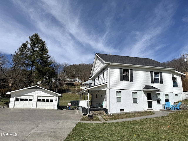 view of front of home featuring a garage, an outbuilding, roof with shingles, a front yard, and crawl space